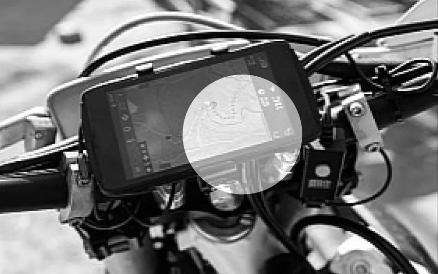A phone mounted on motorcycle handlebars