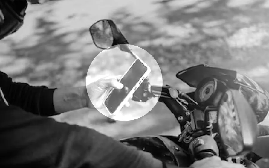 A rider holding a phone while riding