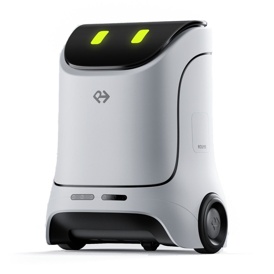 ROUTE, a white wayfinding robot with a black face panel and two green eyes