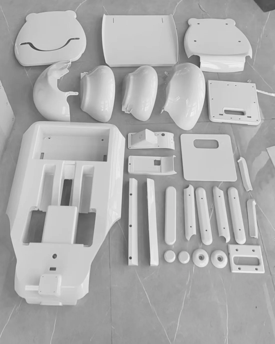 Prototype shell parts laid out on a stone floor